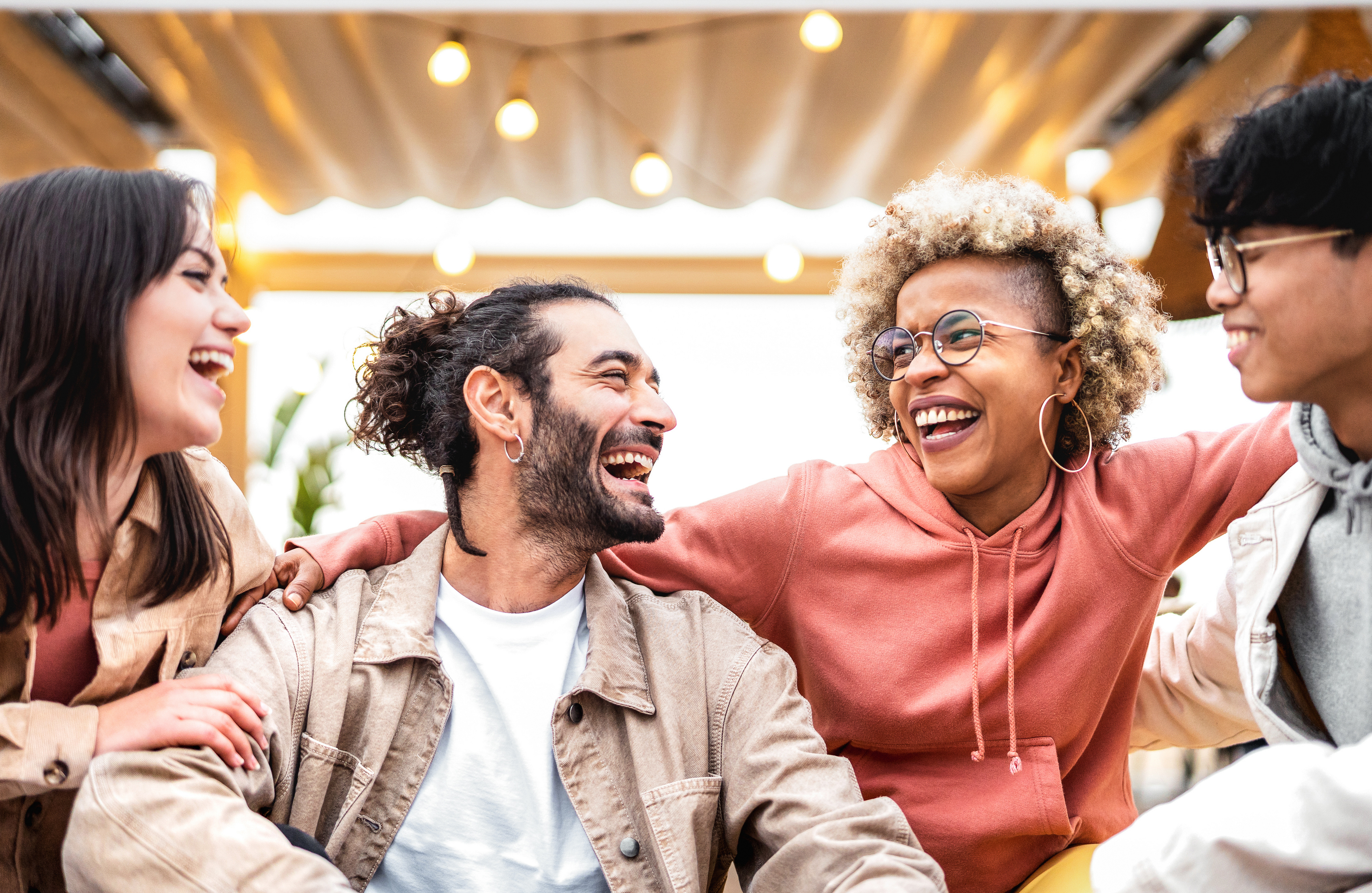 Multi racial friends having fun at fancy venue location – Life style concept with happy men and women sharing time together – College students on cool trendy vacations – Vivid backlight filter
